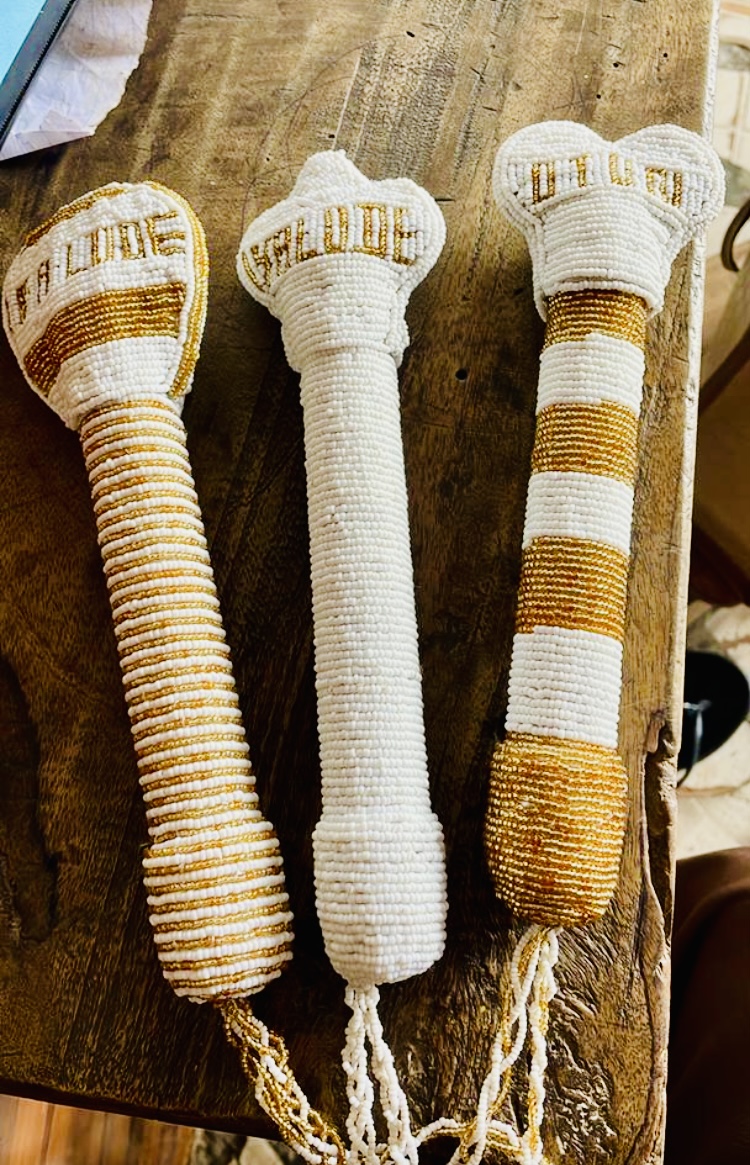 Hand-beaded Osun staffs in white and gold beadwork