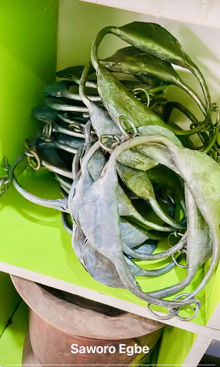 Saworo Egbe metal rattle anklets in green and blue patina